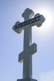 Orthodox cross against the blue sky and the sun. Cross in the backlight of the sun. Symbol of the Christian faith. The inscription stock image Orthodox cross against the blue sky and the sun. Cross in the backlight of the sun. Symbol of the Christian faith. The inscription stock image