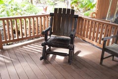 Outdoor dark wooden rocking chair in the garden royalty free stock photos Outdoor dark wooden rocking chair in the garden royalty free stock photos