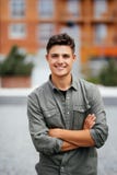 Outdoor portrait of handsome young man walking on the street, looking at camera and smile Stock Images Outdoor portrait of handsome young man walking on the street, looking at camera and smile Stock Images