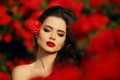 Outdoors portrait of Natural Beauty woman in red roses. Sensual Stock Photography Outdoors portrait of Natural Beauty woman in red roses. Sensual Stock Photography