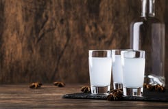 Ouzo - Greek Anise Brandy, Traditional Strong Alcoholic Drink In Glasses On The Old Wooden Table, Place For Text Stock Photo