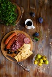 Overhead view of aperitif table Meat snack, fried sausages, cheese, salami, olives and a glass of wine on a dark table Menu and re royalty free stock images Overhead view of aperitif table Meat snack, fried sausages, cheese, salami, olives and a glass of wine on a dark table Menu and re royalty free stock images