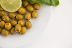 Overhead view of olives with lemon in plate stock photography Overhead view of olives with lemon in plate stock photography