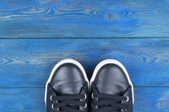 Overhead view of shoes on blue wooden floor. Shoes on a wooden background. Sneakers on a wooden floor. Sport, fitness, shoes, foot royalty free stock photography Overhead view of shoes on blue wooden floor. Shoes on a wooden background. Sneakers on a wooden floor. Sport, fitness, shoes, foot royalty free stock photography