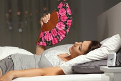Overwhelmed woman fanning suffering heat stroke stock photo Overwhelmed woman fanning suffering heat stroke stock photo