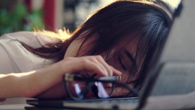 Overworked, Exhausted and tired young businesswoman removes glasses, resting, sleeping over a laptop in a desk at work stock video footage Overworked, Exhausted and tired young businesswoman removes glasses, resting, sleeping over a laptop in a desk at work stock video footage