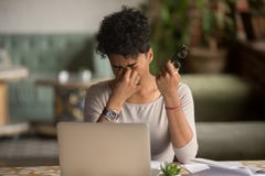 Overworked tired african woman holding glasses feel eye strain royalty free stock image Overworked tired african woman holding glasses feel eye strain royalty free stock image