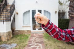 Ownership, property and tenant concept - key in hand for new home and real estate stock image Ownership, property and tenant concept - key in hand for new home and real estate stock image