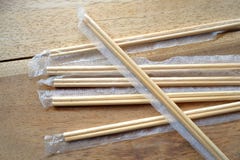 Package of readymade bamboo chopsticks on wooden background Stock Photos Package of readymade bamboo chopsticks on wooden background Stock Photos