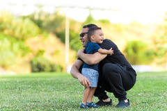 Padre e hijo que abrazan al aire libre imágenes de archivo libres de regalías Padre e hijo que abrazan al aire libre imágenes de archivo libres de regalías