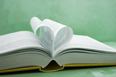 Pages of a book curved into a heart shape stock photo Pages of a book curved into a heart shape stock photo