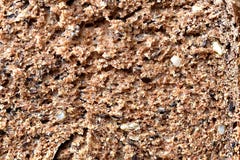 Pain brun complet avec des graines découpées en tranches Instruction-macro Texture photos stock Pain brun complet avec des graines découpées en tranches Instruction-macro Texture photos stock