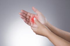 Pain in the joints of the hands. Carpal tunnel syndrome. Pain in the human body on a gray background stock photography Pain in the joints of the hands. Carpal tunnel syndrome. Pain in the human body on a gray background stock photography