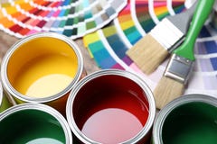 Paint Cans, Color Palette Samples And Brushes On Table Stock Photo Paint Cans, Color Palette Samples And Brushes On Table Stock Photo