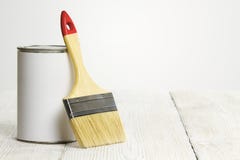 Paintbrush and can, paint brush and white color on wooden floor royalty free stock images Paintbrush and can, paint brush and white color on wooden floor royalty free stock images