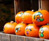 Painted decorative organic pumpkins in a market stock image Painted decorative organic pumpkins in a market stock image