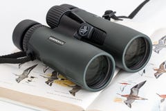 Pair of binoculars on a book Pair of binoculars on a book