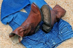 Pair of cowboy boots and blue jeans on straw royalty free stock photo Pair of cowboy boots and blue jeans on straw royalty free stock photo