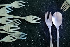 A pair of cutlery and a fork without a pair stock photography A pair of cutlery and a fork without a pair stock photography