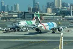 A pair of Emirates Airlines Airplanes with Expo 2020 logos. They park at the Dubai International Airport royalty free stock images A pair of Emirates Airlines Airplanes with Expo 2020 logos. They park at the Dubai International Airport royalty free stock images