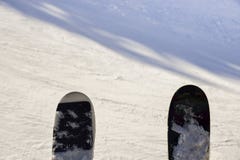 Pair of skis captured at a chairlift looking down onto piste stock photos Pair of skis captured at a chairlift looking down onto piste stock photos