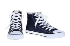 Pair of womens high top lace up dark navy blue sneakers isolated on white background Stock Images Pair of womens high top lace up dark navy blue sneakers isolated on white background Stock Images