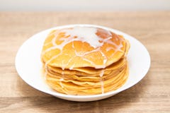 Pancakes with condensed milk on a white light background. A stack of pancakes with sweet sauce. Close up view. stock images Pancakes with condensed milk on a white light background. A stack of pancakes with sweet sauce. Close up view. stock images