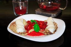 Pancakes with ice cream drizzled with strawberry and mint, teapo royalty free stock photography Pancakes with ice cream drizzled with strawberry and mint, teapo royalty free stock photography