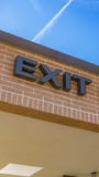 Panorama Exit only sign on the exterior brick wall of a building with shiny window stock photo Panorama Exit only sign on the exterior brick wall of a building with shiny window stock photo