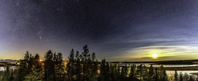 Panorama of full moon and stars in clear sky shines over Scandinavian wild forest, lakes, swamps, long exposure night photo,