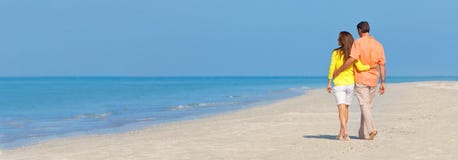 Panoramic Banner Couple Walking on An Empty Beach stock photo Panoramic Banner Couple Walking on An Empty Beach stock photo