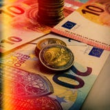 Paper Euro Banknotes And Coins. The Coin Is Two Euros. Royalty Free Stock Photo