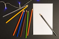 Paper with pencils on a dark background royalty free stock photo Paper with pencils on a dark background royalty free stock photo