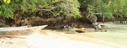 Papuan family with boat