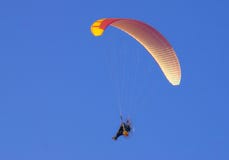 Paraglider enjoying the bright skies.