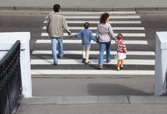 Parents Holds Hand Of Children And Crossing Road Royalty Free Stock Photography
