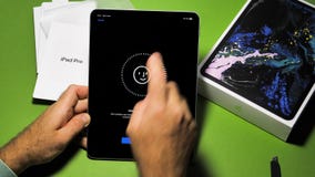 Man unboxing unpacking new Apple Computers iPad Pro