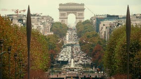 PARIS, FRANCE - OCTOBER 8, 2017. Car traffic jam near famous Arc de Triomphe or Triumphal Arch, telephoto lens shot stock video PARIS, FRANCE - OCTOBER 8, 2017. Car traffic jam near famous Arc de Triomphe or Triumphal Arch, telephoto lens shot stock video