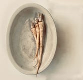 Parsley root in an antique cream colored bowl, left of center stock images Parsley root in an antique cream colored bowl, left of center stock images
