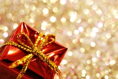 Part of christmas red gift box with yellow bow on glitter silver and gold background stock photography Part of christmas red gift box with yellow bow on glitter silver and gold background stock photography