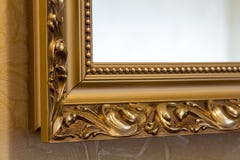 Part of the ornate, golden color carved mirror frame in ancient Royalty Free Stock Photo Part of the ornate, golden color carved mirror frame in ancient Royalty Free Stock Photo