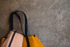 Part of yellow leather female bag on grey wall backgroud stock image Part of yellow leather female bag on grey wall backgroud stock image
