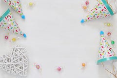 Party hat next to colorful confetti on wooden table stock images Party hat next to colorful confetti on wooden table stock images