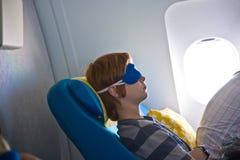 Pasajero joven que duerme en los aviones fotografía de archivo libre de regalías Pasajero joven que duerme en los aviones fotografía de archivo libre de regalías