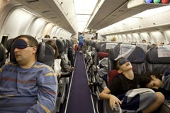 The passengers are sleeping in the cabin in flight Royalty Free Stock Image The passengers are sleeping in the cabin in flight Royalty Free Stock Image
