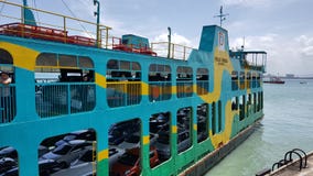 Passengers and their cars using public ferry stock photography Passengers and their cars using public ferry stock photography