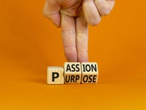 Passion or purpose symbol. Businessman turns wooden cubes and changes the concept word `purpose` to `passion` on a beautiful