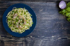 Pasta carbonara with pork, fresh herbs, sprinkled with sesame on top of a blue plate. Dark wooden background. View from above stock photos Pasta carbonara with pork, fresh herbs, sprinkled with sesame on top of a blue plate. Dark wooden background. View from above stock photos
