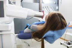 Patient Using Xray Machine While Lying On Chair In Dentistry royalty free stock image Patient Using Xray Machine While Lying On Chair In Dentistry royalty free stock image