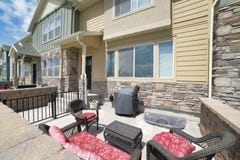 Patio of a townhouse with woven set of couch and armchairs